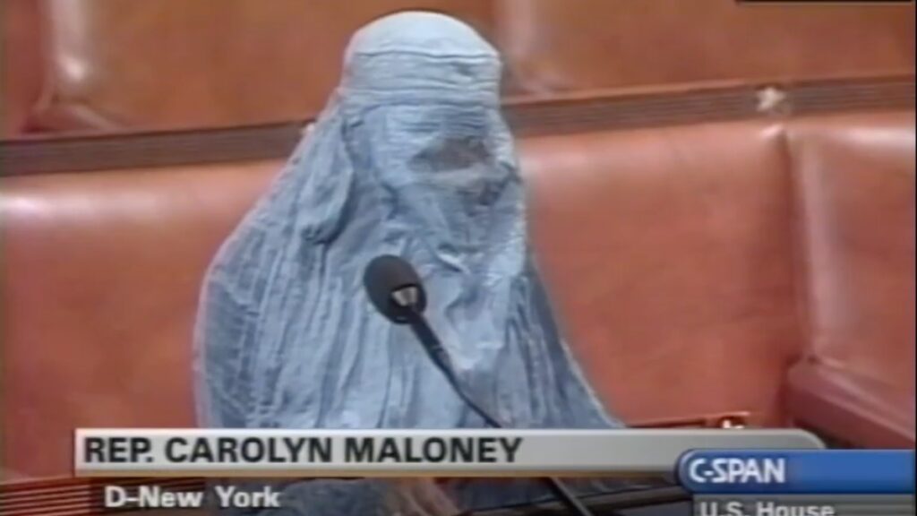 Rep. Carolyn Maloney wears a traditional Afghani burqa on Oct. 16, 2001 while speaking in support of American military involvement in Afghanistan in the U.S. House of Representatives. (Image via CSPAN/U.S. Congress)